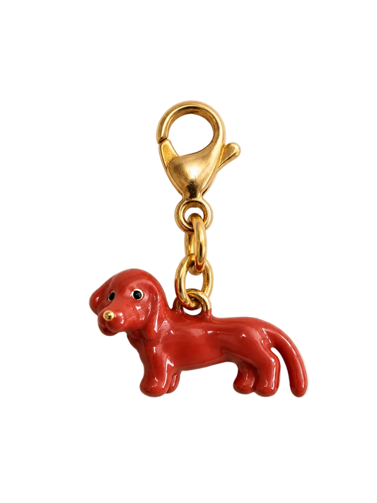 A red dog-shaped charm with a gold lobster clasp, shown on a plain white background.