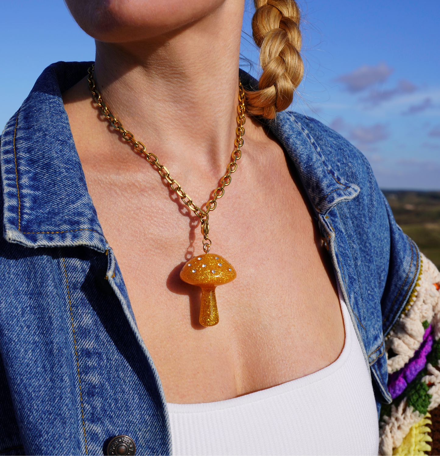 golden yellow mushroom charm on a gold necklace