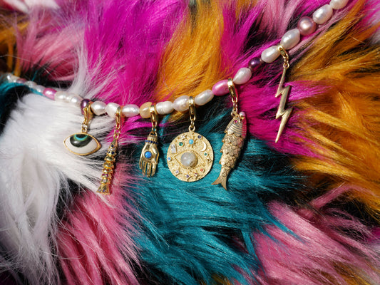 Colorful feathered accessory with gold eye charm and beads