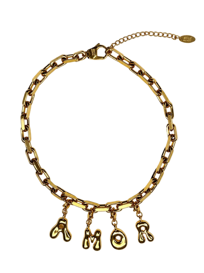A gold-tone chunky chain MILLIE MADNESS necklace with dangling letter charms spelling 'AMOR', displayed on a clean white background.