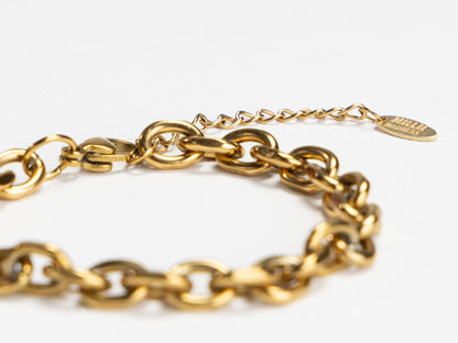 Gold chain bracelet on a white background