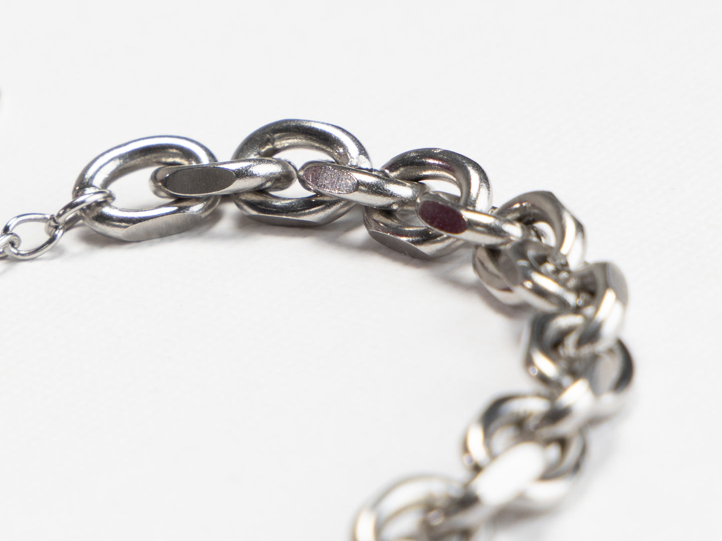 Close-up of a silver chain bracelet on a white background