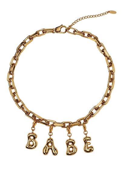 Gold-tone chunky chain millie madness necklace with dangling letter charms spelling 'BABE' on a white background.