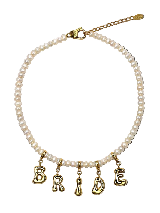 A pearl millie madness necklace with gold letter charms spelling 'BRIDE' on a clean white background.
