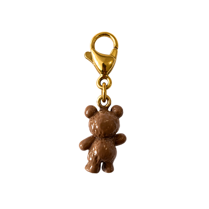 Brown teddy bear charm with gold clasp on a white background