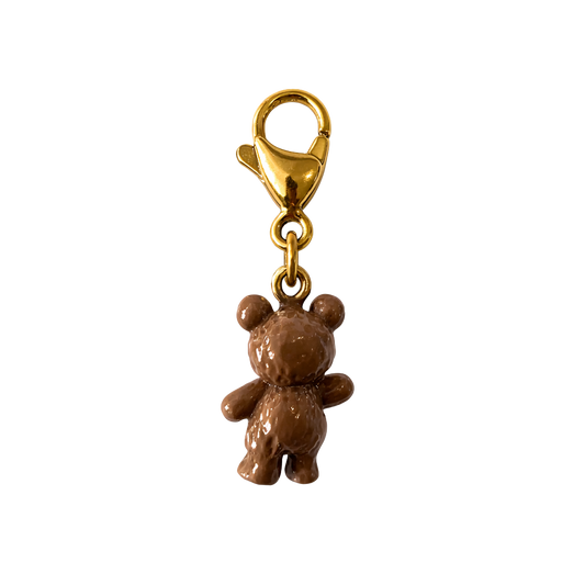 Brown teddy bear charm with gold clasp on a white background