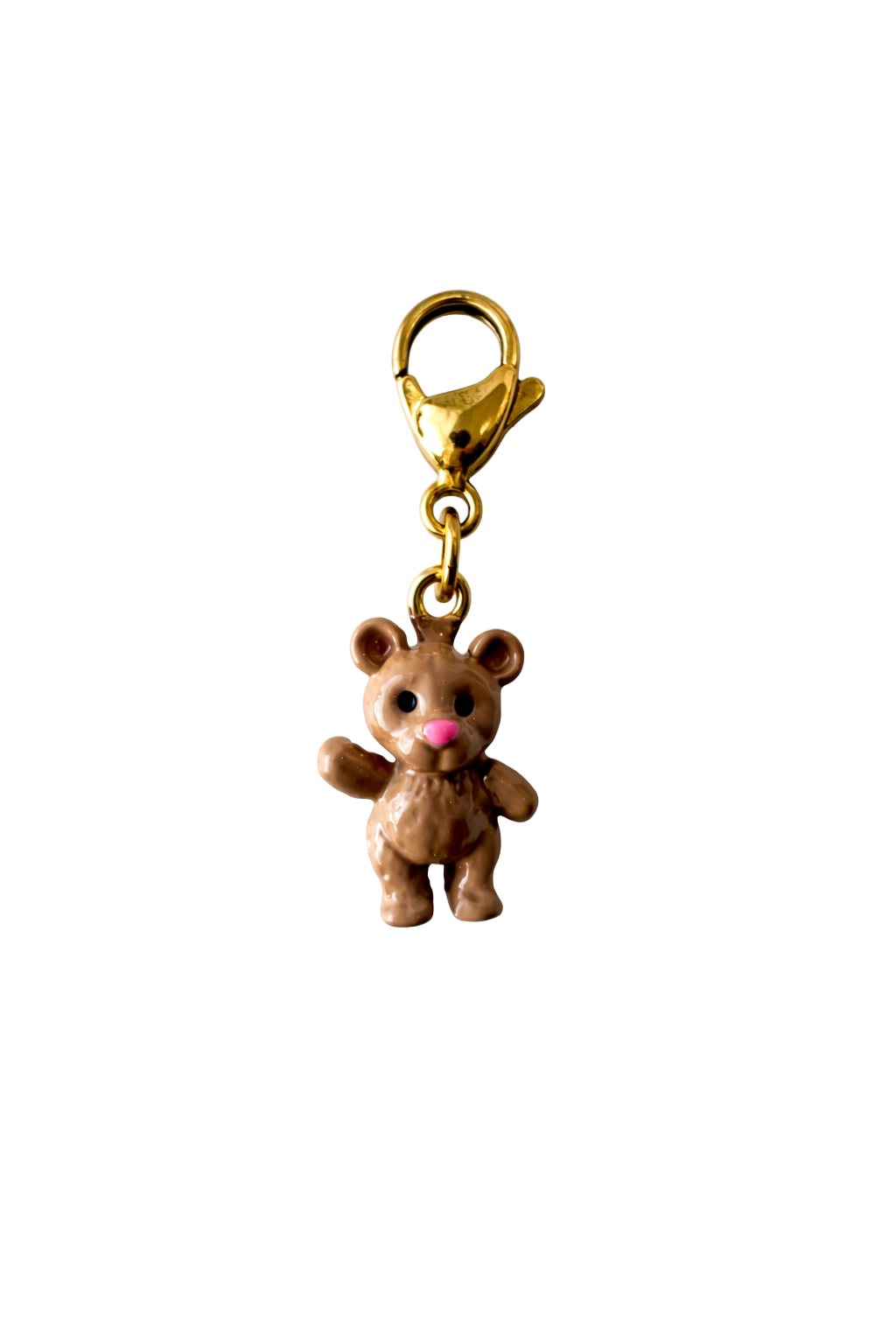 Gold teddy bear charm on a white background