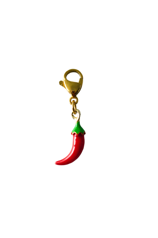 Red chili pepper keychain with green stem on a white background