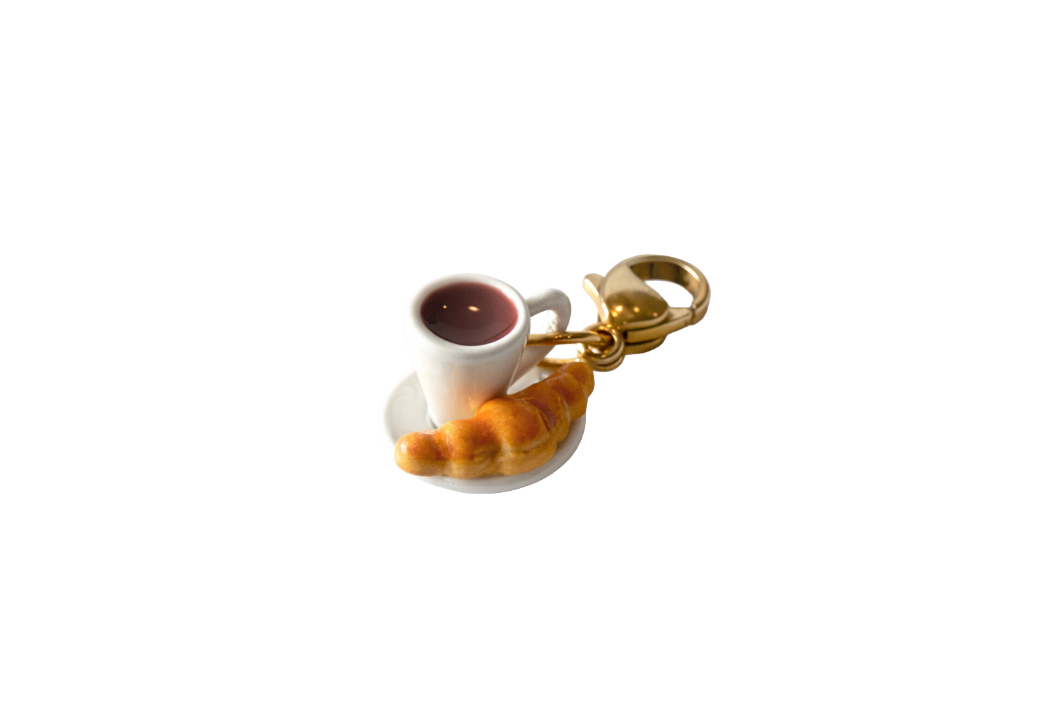 Keychain with a miniature cup of coffee and pastry on a white background