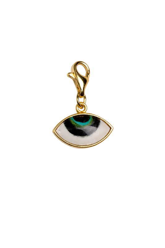 Gold pendant with eye design on a white background