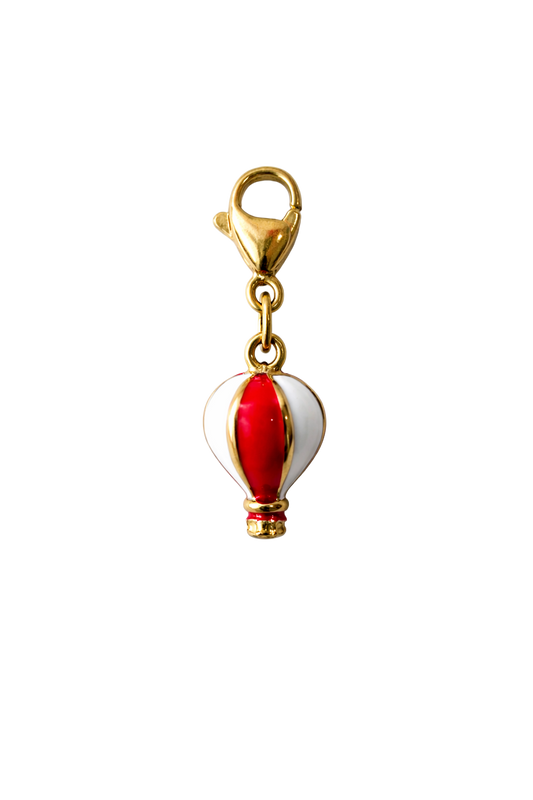 Hot air balloon charm with gold accents on a white background