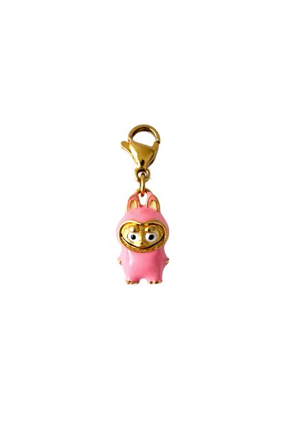 Pink labubu charm with gold accents on a white background
