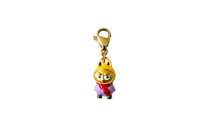 Gold labubu charm with a cartoon character wearing a red dress and gold crown on a white background