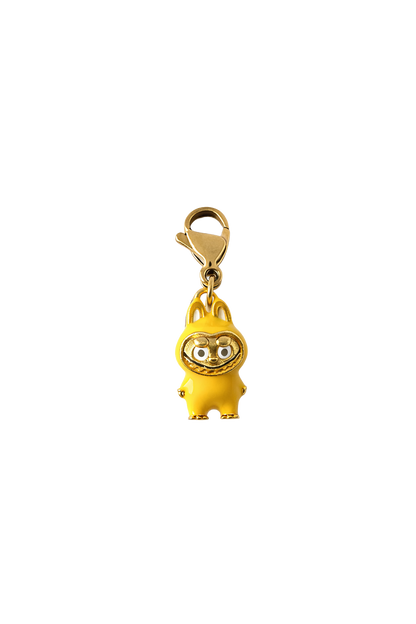 Gold-colored labubu charm with a cartoon character on a white background