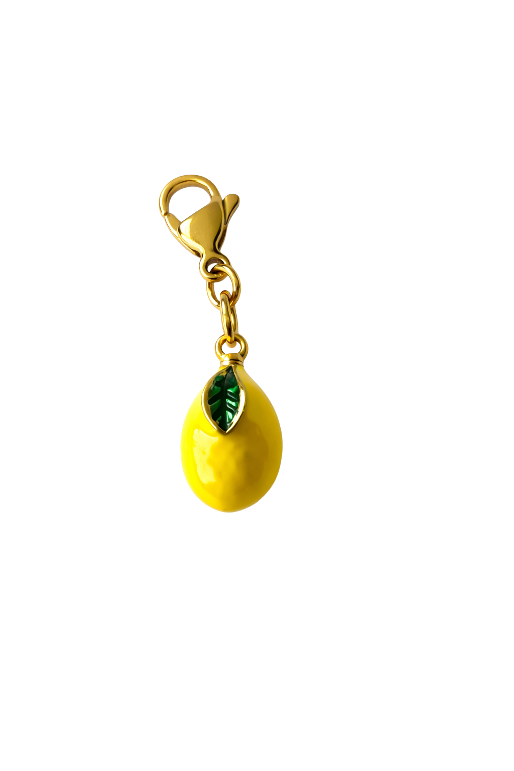 Yellow lemon-shaped charm with a green leaf on a white background