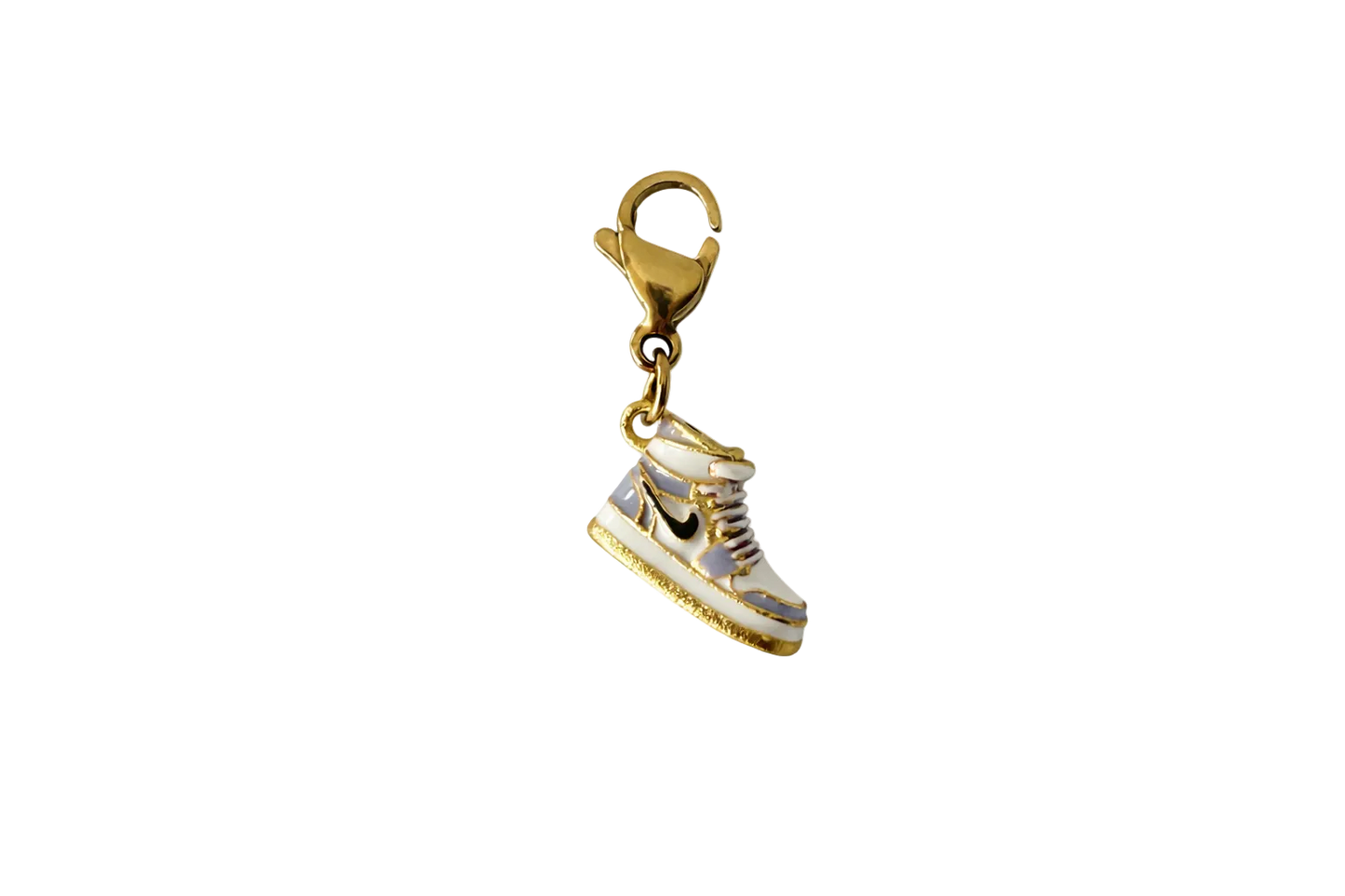 Gold and white sneaker charm on a white background