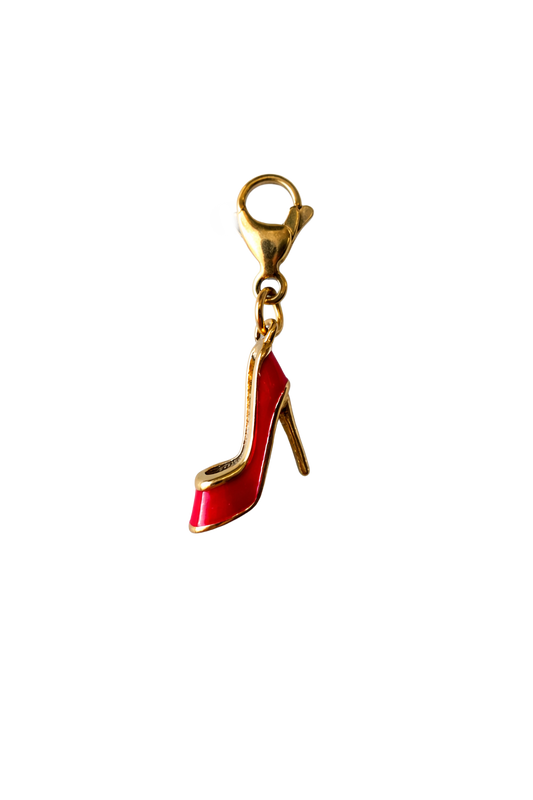Red high-heeled shoe charm with gold clasp on a white background