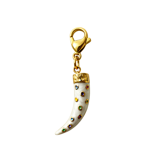 Gold and white horn-shaped charm with colorful accents on a white background