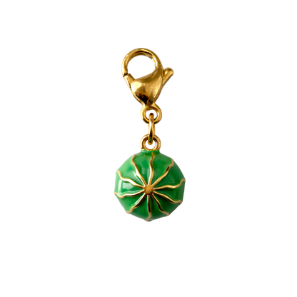 Gold and green watermelon charm on a white background