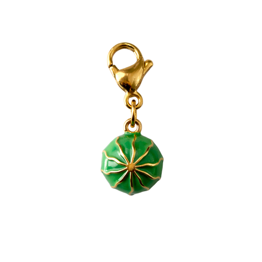 Gold and green watermelon charm on a white background