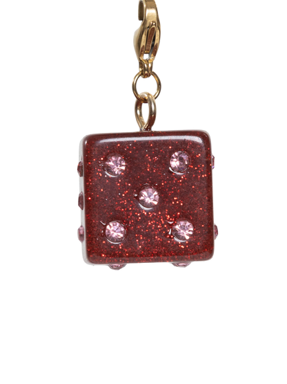 Red glittery charm with gold clasp on a white background