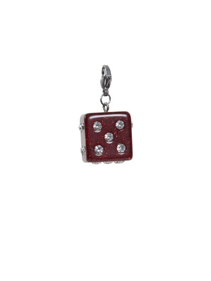 Dice-shaped charm with embedded crystals on a white background