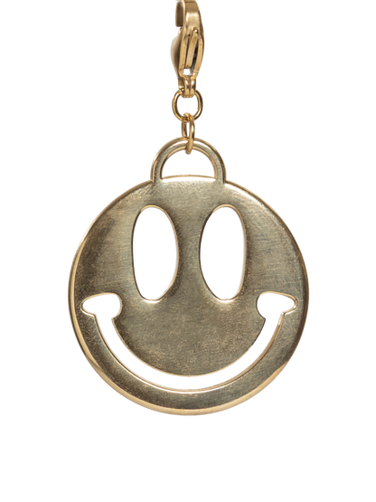 Gold stainless steel smiley face charm on a white background