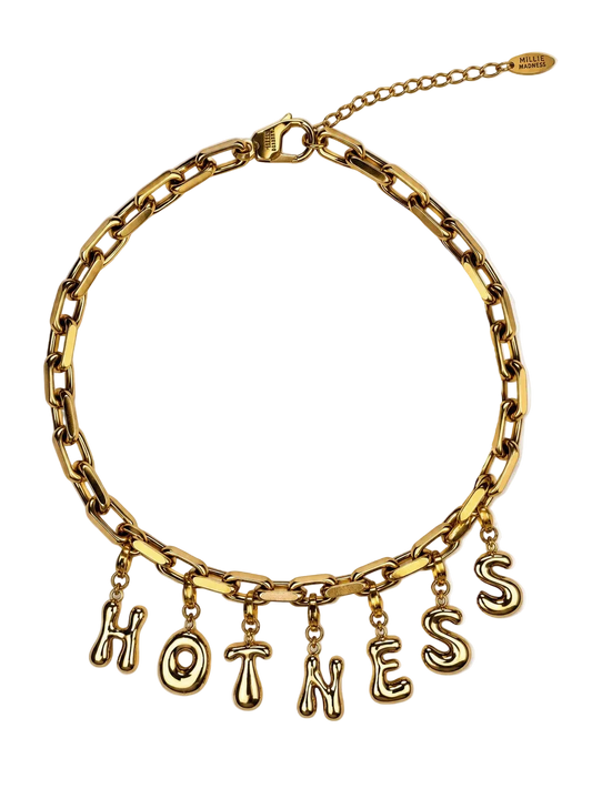 A gold-tone chain millie madness necklace with dangling letters spelling 'HOTNESS' on a clean white background.