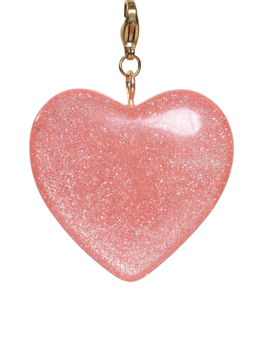 Pink heart-shaped charm with gold clasp on a white background