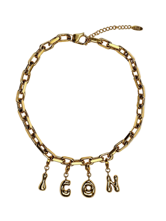 A gold-toned chunky chain MILLIE MADNESS necklace with dangling letter charms spelling 'CON' on a plain white background.