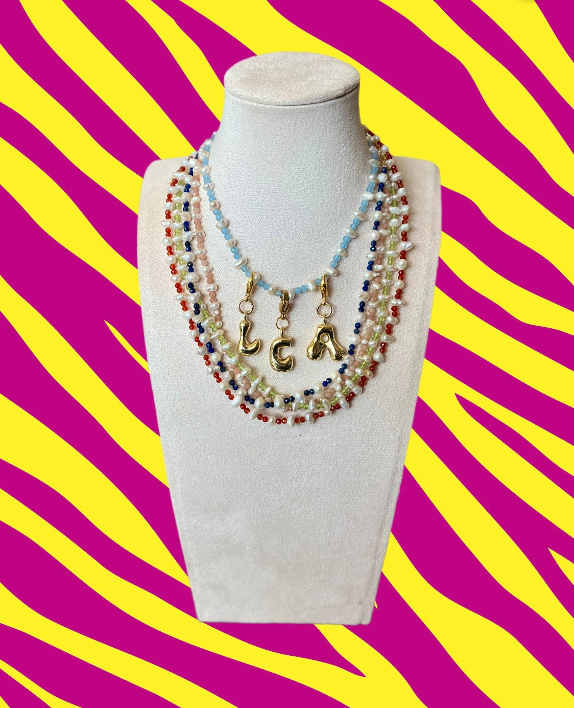 Semi precious stones with pearls and gold letter charm