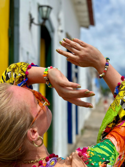 Colorful bracelets and accessories on a street background