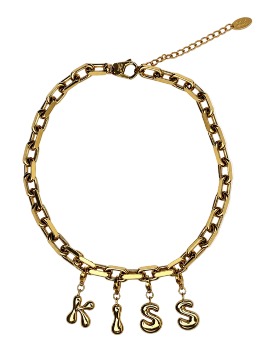 A gold-toned chain millie madness necklace with four dangling letter charms spelling 'KISS' in a stylized font, displayed on a clean white background.