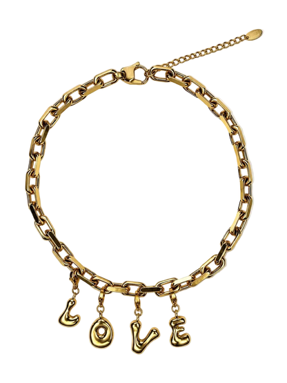 A gold-tone chain MILLIE MADNESS necklace with four dangling letter charms spelling out 'LOVE', displayed on a clean white background.