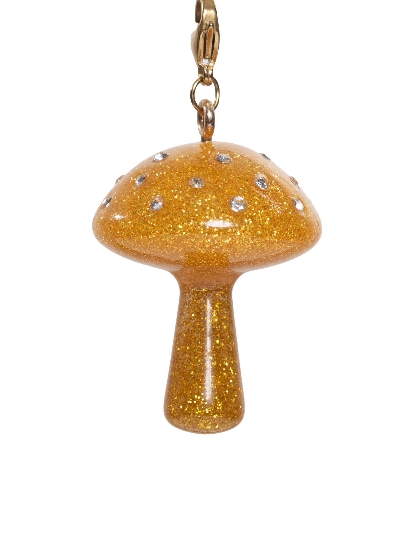 Gold glittery mushroom charm with rhinestones on a gold stainless steel clasp on a white background
