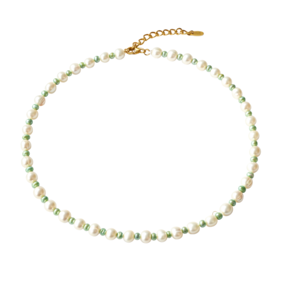 Necklace with white and green pearls on a white background