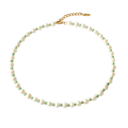Necklace with white and green pearls on a white background