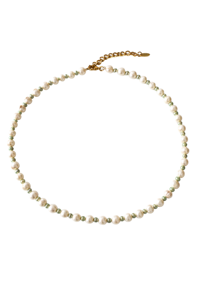 Necklace with white and green pearls on a white background
