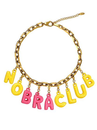 A gold-tone chain Millie Madness necklace with dangling letter charms spelling 'NO BRA CLUB' in alternating yellow and pink letters, shown on a plain white background.
