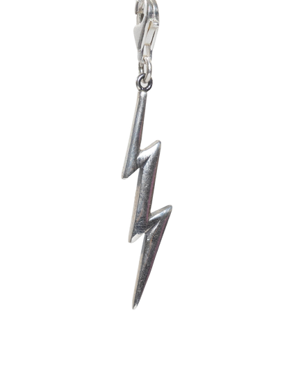 Real Silver lightning bolt charm on a white background