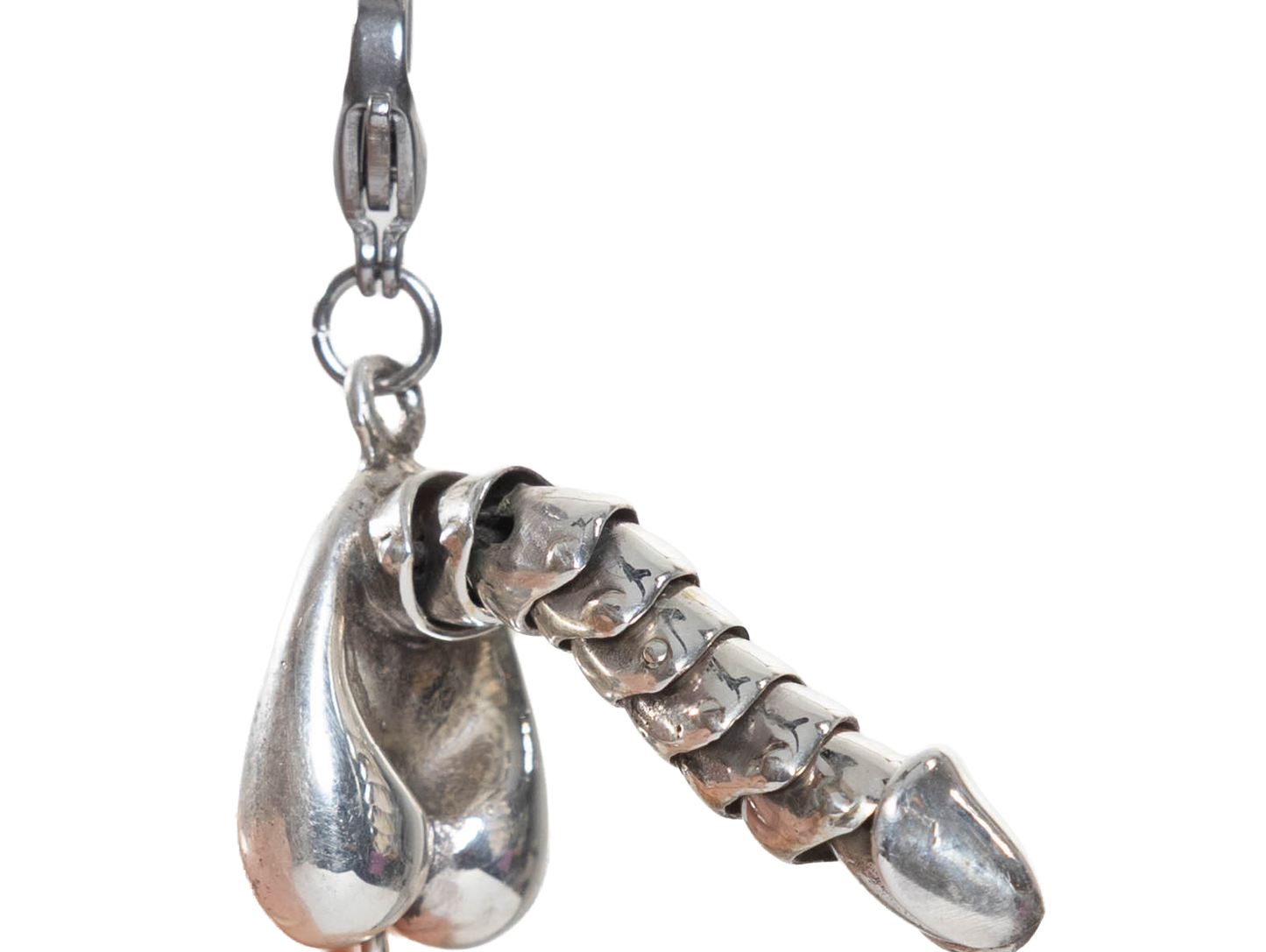 Sterling silver penis charm on a white background