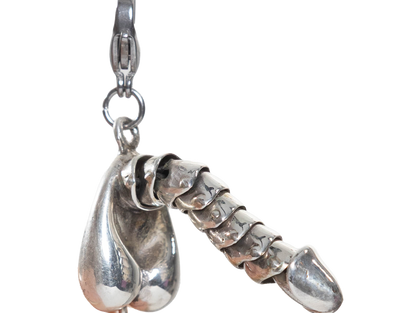 Sterling silver penis charm on a white background