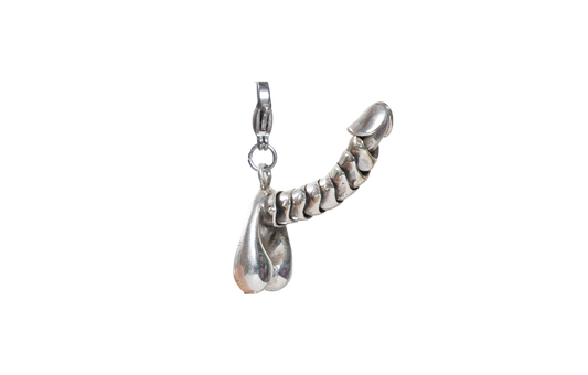 Silver penis charm on a white background