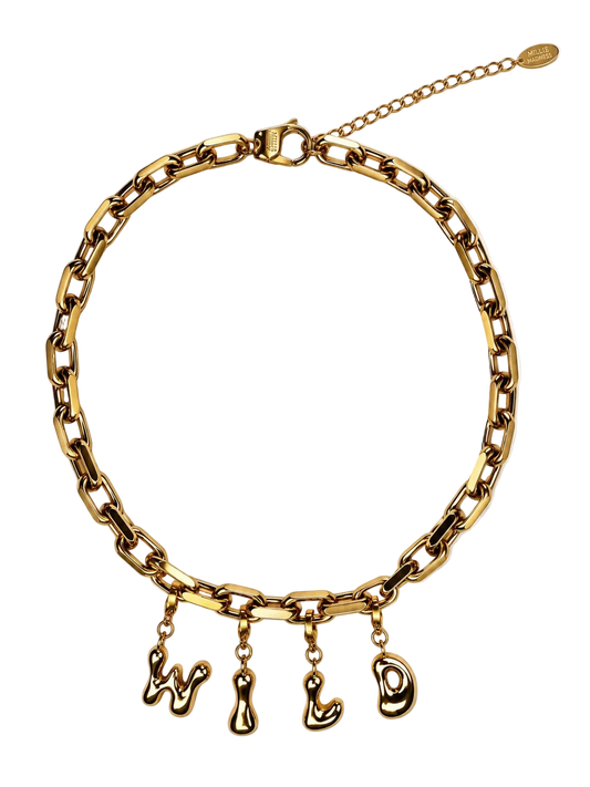 Gold-tone chunky chain millie madness necklace with dangling stylized letter charms on a white background.