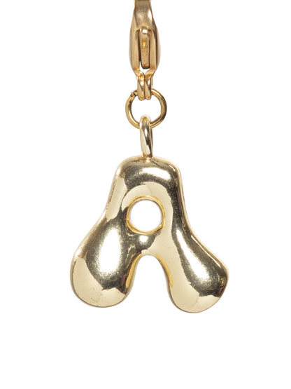 Gold letter charm on a white background