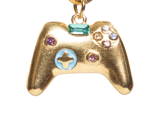 Gold-colored gaming controller charm with colorful stones on a white background