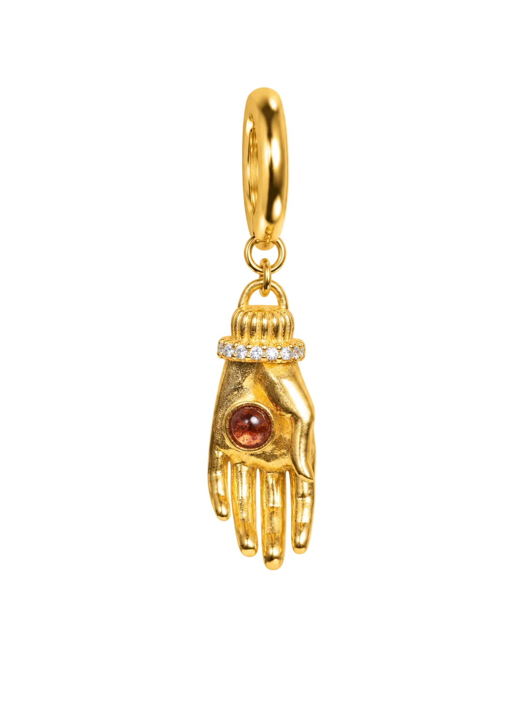 A gold millie madness earring shaped like a hand, featuring a small round amber-red gemstone on the back of the hand and a row of tiny clear stones around the wrist, suspended from a gold ring on a plain white background.