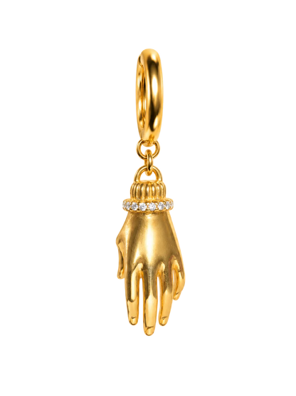 A gold millie madness earing charm shaped like a hand with a small ring of clear stones around the wrist, hanging from a gold loop on a plain white background.