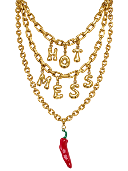 A gold multi-layered millie madness chain necklace featuring dangling letters spelling 'HOT MESS' and a red chili pepper charm at the bottom, shown on a plain white background.