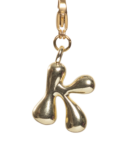Gold plated letter K charm stainless steel clasp on a white background